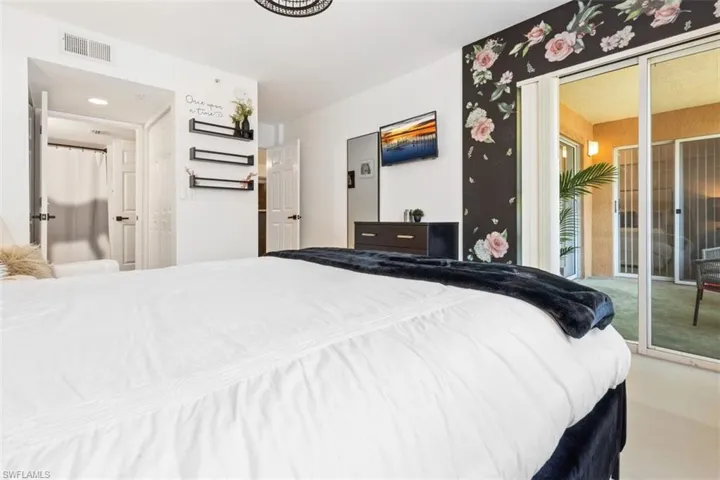 Carpeted bedroom with access to outside