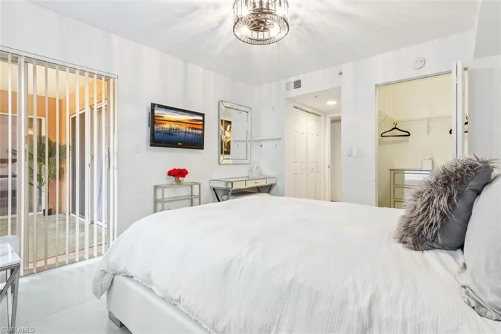 Bedroom featuring access to outside, concrete floors, and a closet