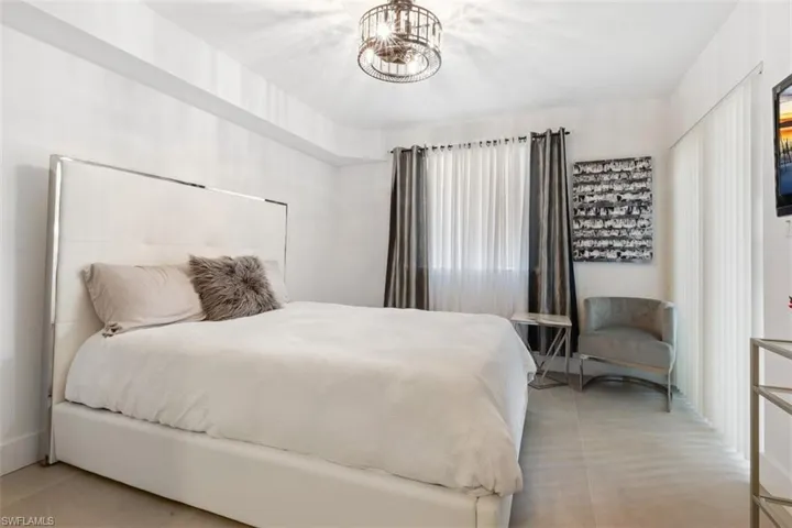 Bedroom featuring a notable chandelier