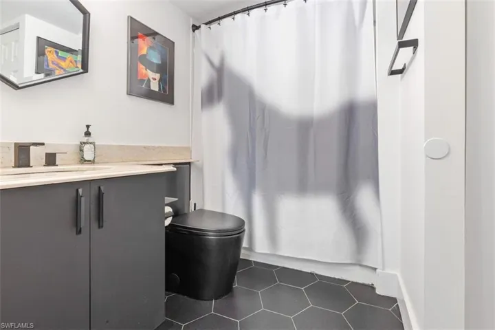 Bathroom featuring tile floors, toilet, and vanity