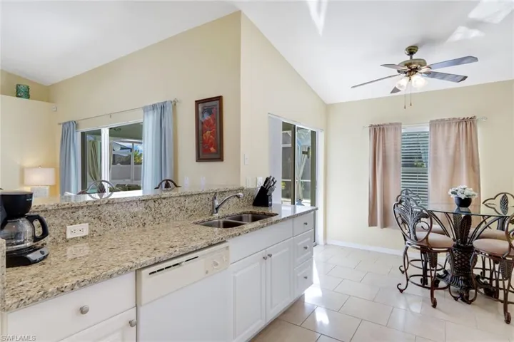 Open plan Kitchen area with eat in Dining area + sliding doors to the Pool Deck