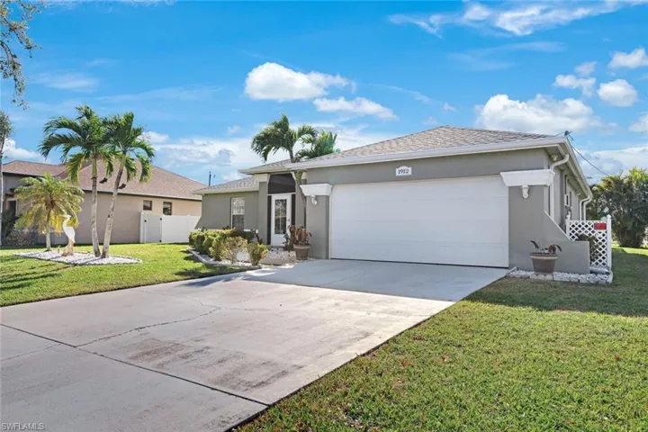 The front of the home with 2 car garage + large driveway