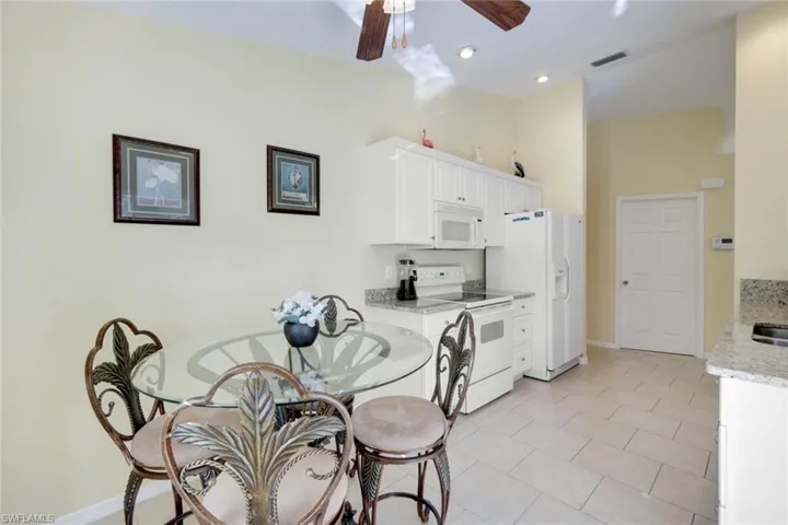 The eat in area set in the Kitchen.  Sliding doors lead the pool area