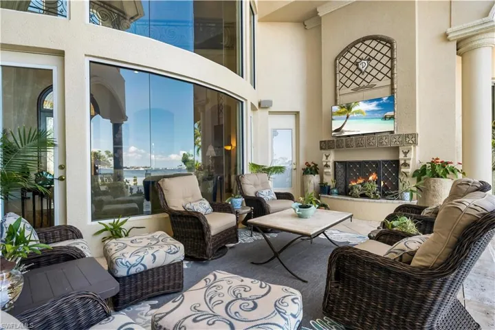 Fabulous covered area with a fireplace.Door on right leads to a full pool bath with a private STEAM ROOM!