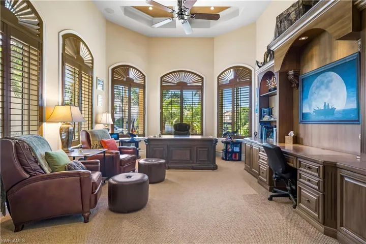 The office has built ins along the right side of the room. Custom plantation shutters, tray ceiling.