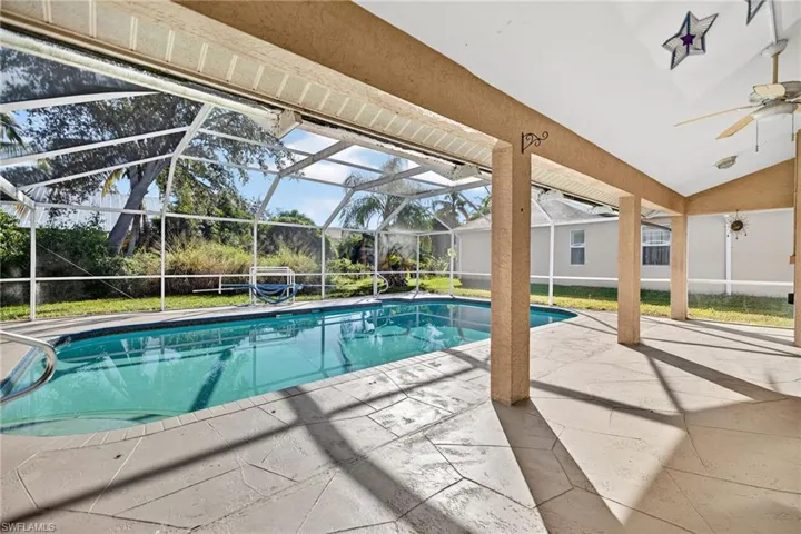 Outdoor pool with a patio, a sunroom, a lanai, and ceiling fan