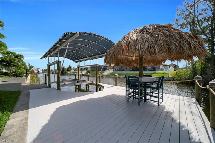 Dock area with boat lift and a water view