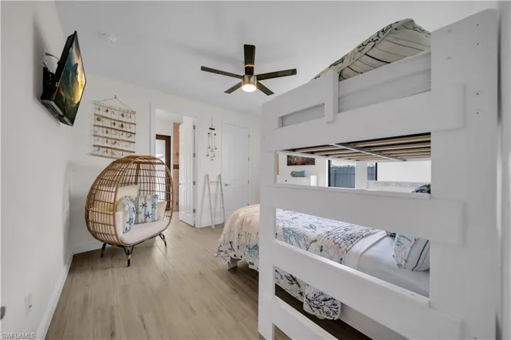 Bedroom with baseboards, wood finished floors, and ceiling fan
