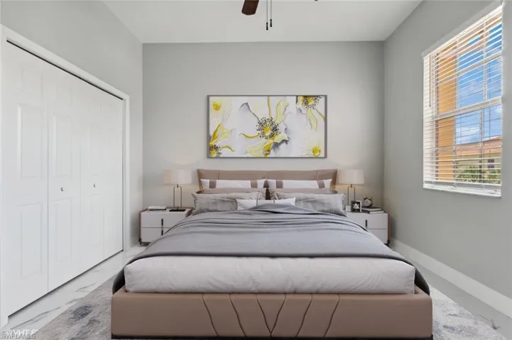 Bedroom featuring tile flooring, ceiling fan, and a closet