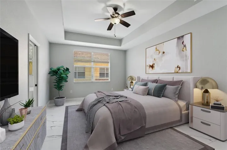 Tiled bedroom featuring a raised ceiling and ceiling fan