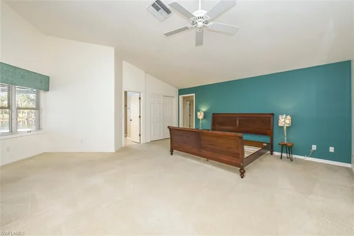 Master Bedroom Carpeted bedroom with vaulted ceiling and ceiling fan