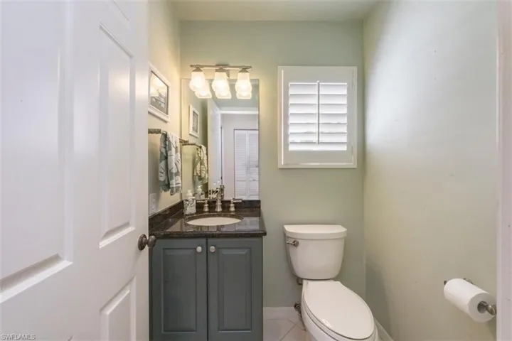 Half bath featuring vanity and light tile patterned floors