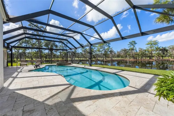 Outdoor Pool and Spa featuring a lanai, a water view, a patio, and a sunroom