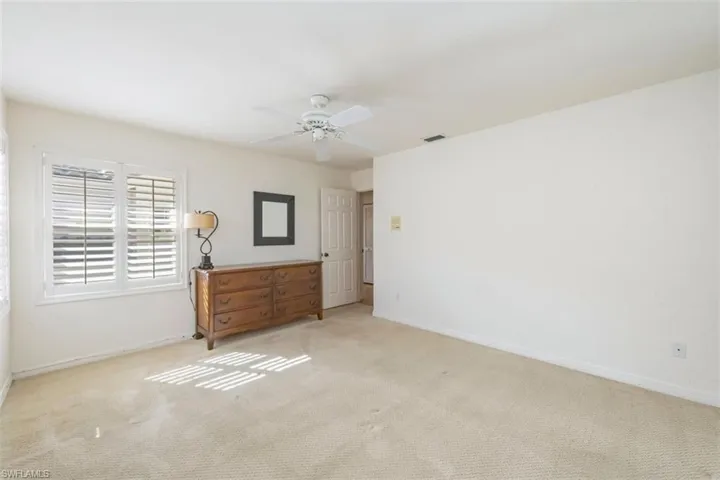 Unfurnished bedroom with carpet floors and ceiling fan