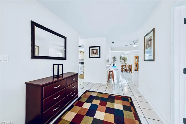 Hall featuring light tile patterned floors