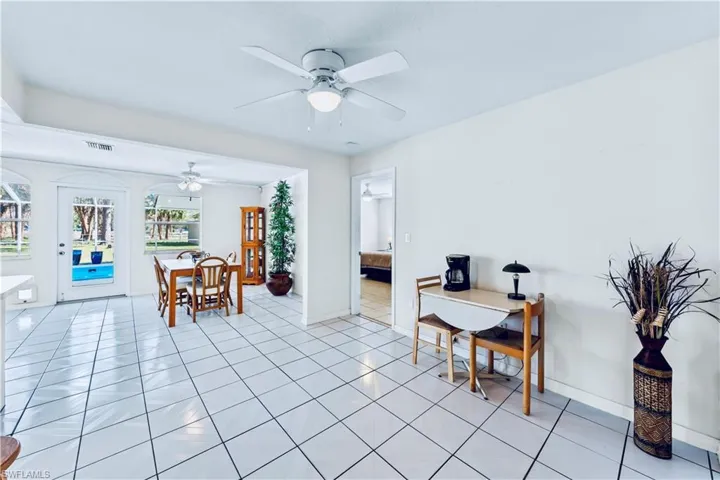 Dining space featuring ceiling fan and light tile patterned flooring