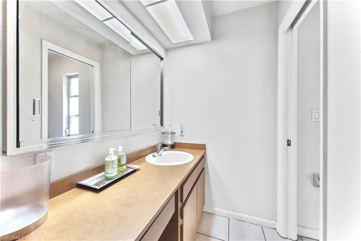 Bathroom with tile patterned floors and vanity
