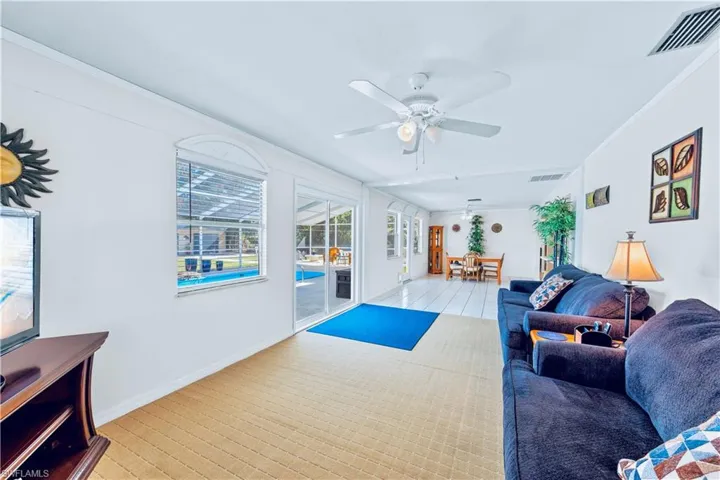 Living room with ceiling fan and crown molding