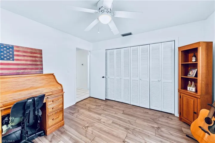 Office space with ceiling fan and light hardwood / wood-style flooring
