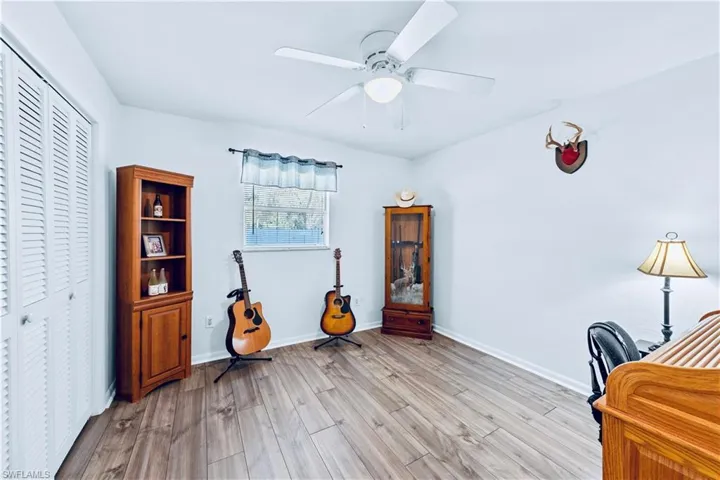 Office space featuring ceiling fan and light hardwood / wood-style floors