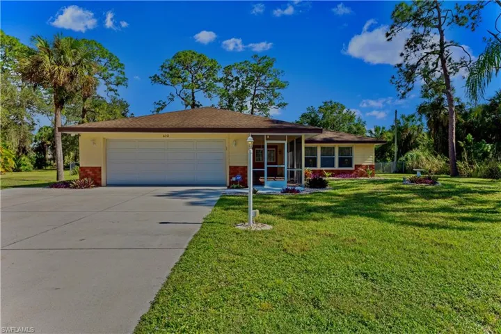 Single story home featuring a front lawn and a garage
