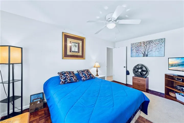 Bedroom with ceiling fan and parquet floors
