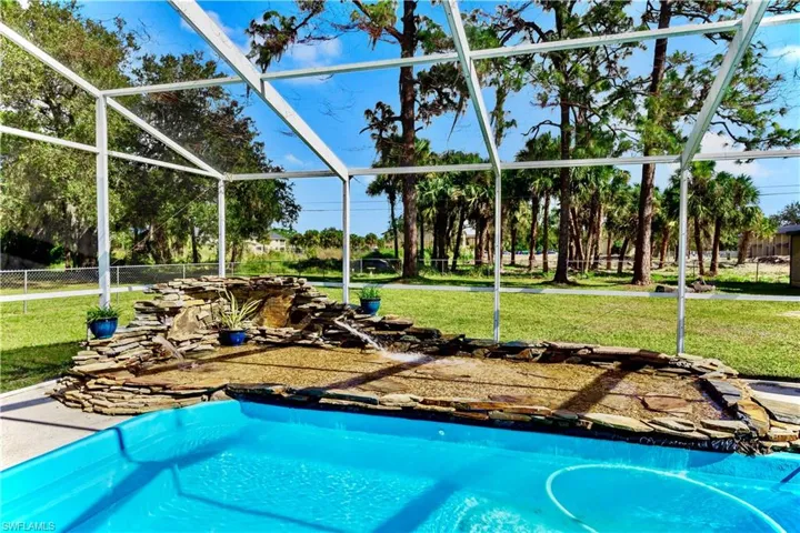 View of swimming pool with glass enclosure