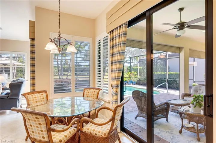 Dining area featuring plenty of natural light, light tile patterned floors, a ceiling fan, and hanging lights