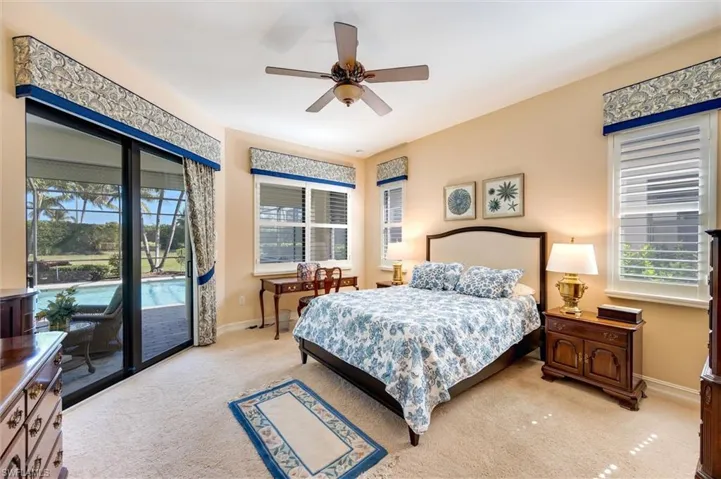 Bedroom featuring access to outside, light colored carpet, and ceiling fan