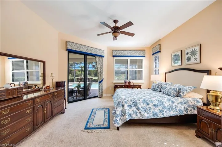Bedroom featuring light colored carpet, access to outside, and a ceiling fan