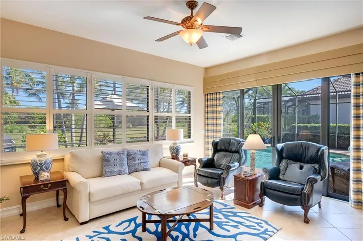 Sunroom / solarium featuring a ceiling fan, outdoor furniture, tile patterned floors, and a patio
