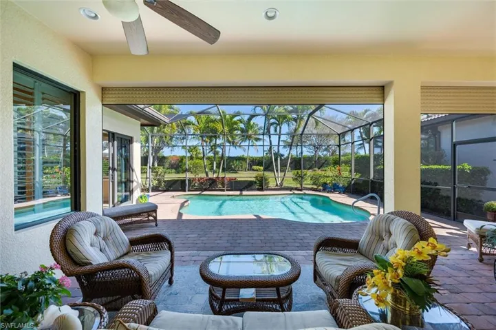 Outdoor pool with a patio, a sunroom, glass enclosure, and outdoor lounge area
