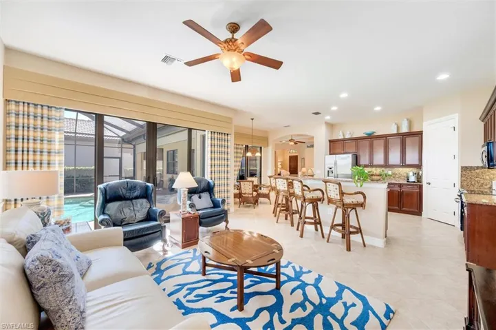 Living area featuring ceiling fan, a sunroom, recessed lighting, and light tile patterned floors