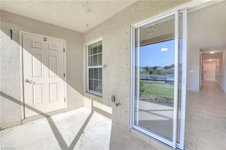 Property entrance with stucco siding and a water view