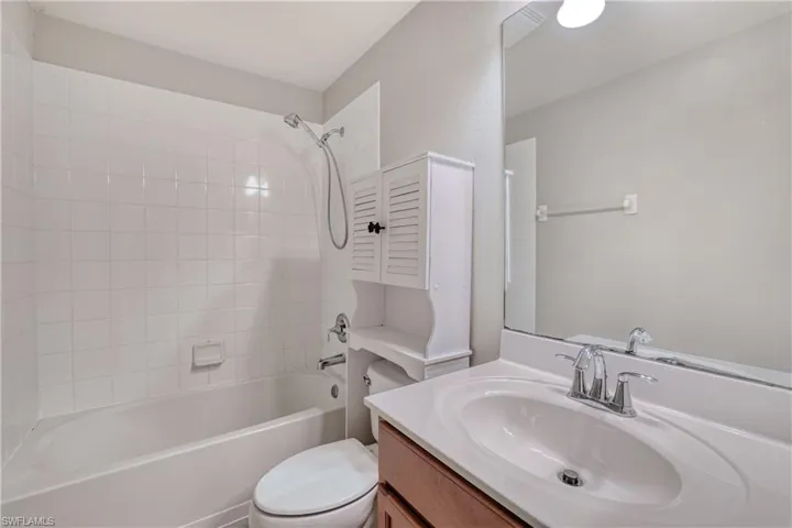 Full bathroom with toilet,  shower combination, and vanity