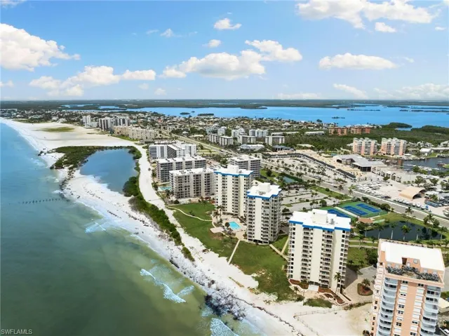 Aerial view featuring a water view and a view of the beach