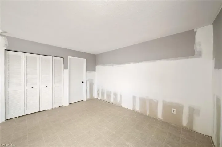 Unfurnished bedroom featuring a closet and light tile patterned flooring