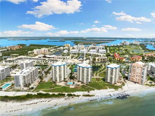 Drone / aerial view featuring a beach view and a water view