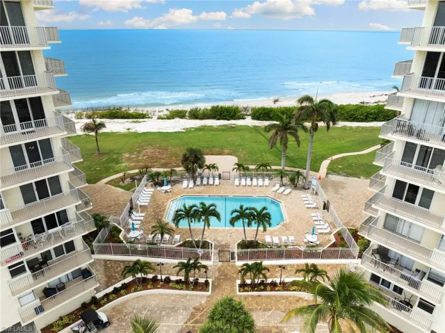 View of pool featuring a yard, a view of the beach, and a water view