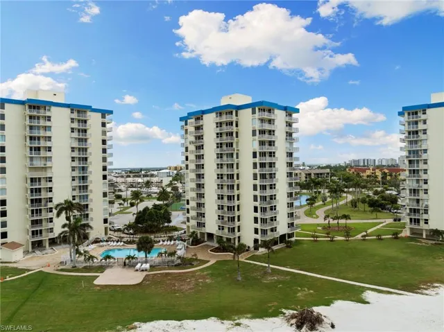 View of building exterior with a community pool