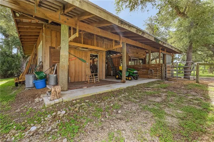 Rear view of property featuring an outbuilding
