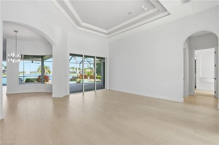 Living Room with slider to lanai and long lake view