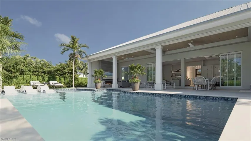 Back of house featuring a yard, a patio, and an outdoor fire pit