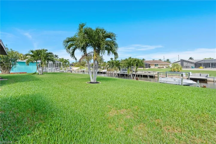 View of yard with a water view and a boat dock