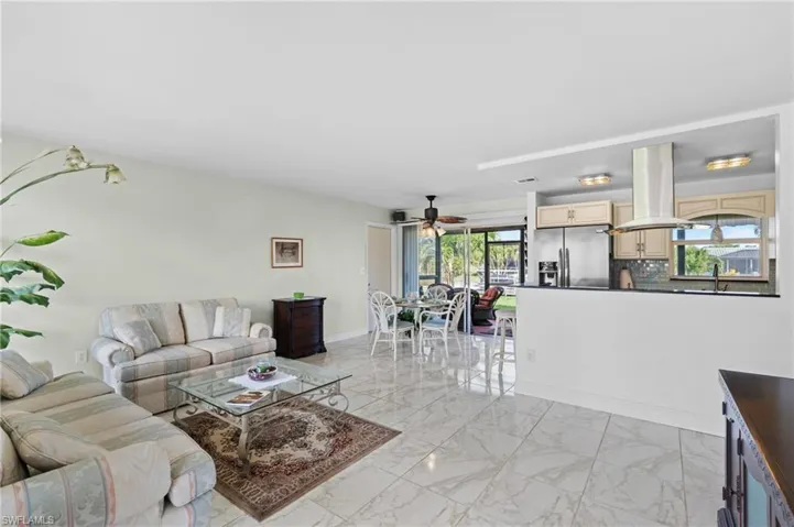 Living room featuring sink and ceiling fan