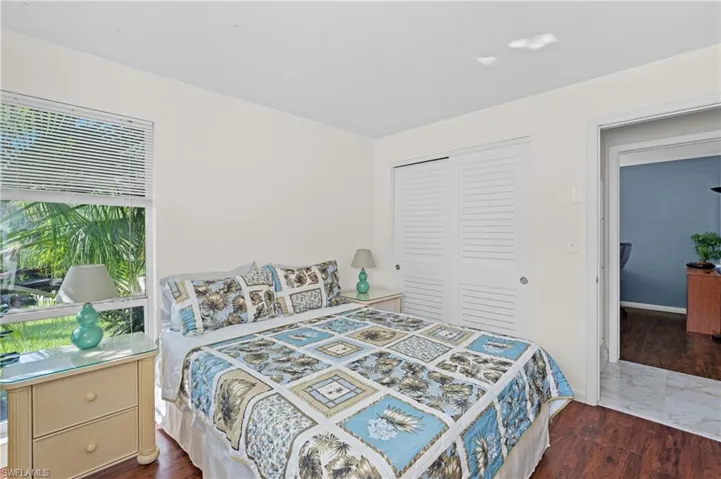 Bedroom featuring dark hardwood / wood-style floors and a closet