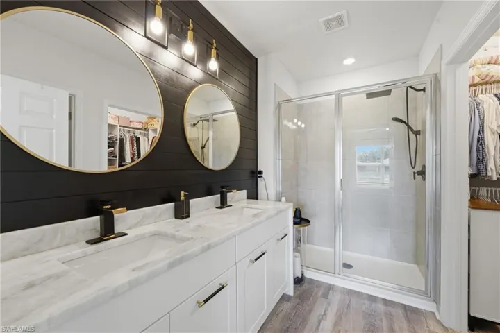 Upgraded primary ensuite with waterfall cabinetry, dual undermount sinks, and a customized walk-in closet.