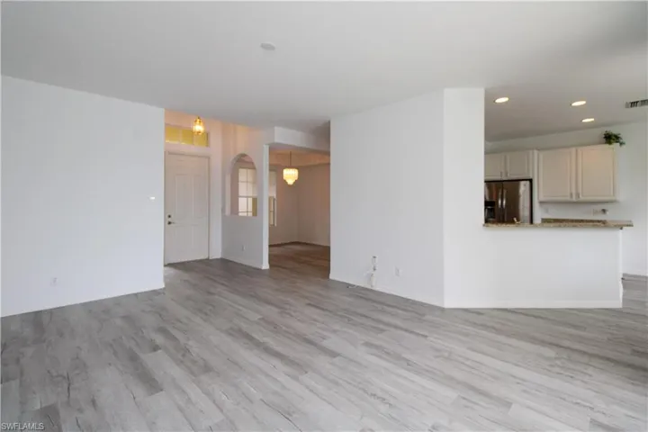 Unfurnished living room with light wood-type flooring and recessed lighting