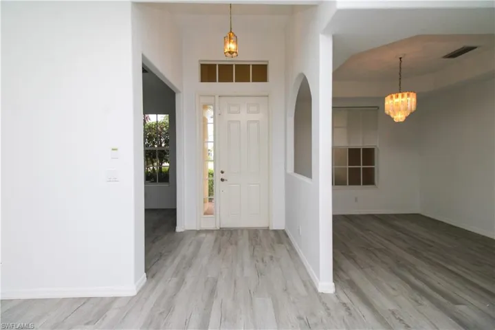 Entryway with a chandelier and wood finished floors
