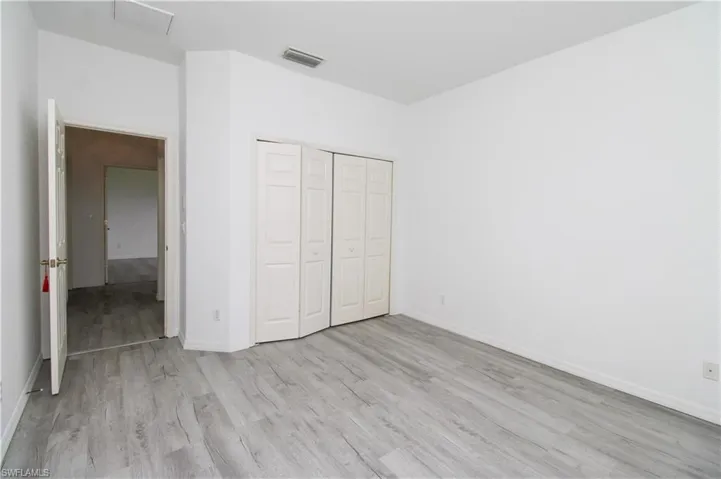 Unfurnished bedroom featuring light wood-style flooring and a closet